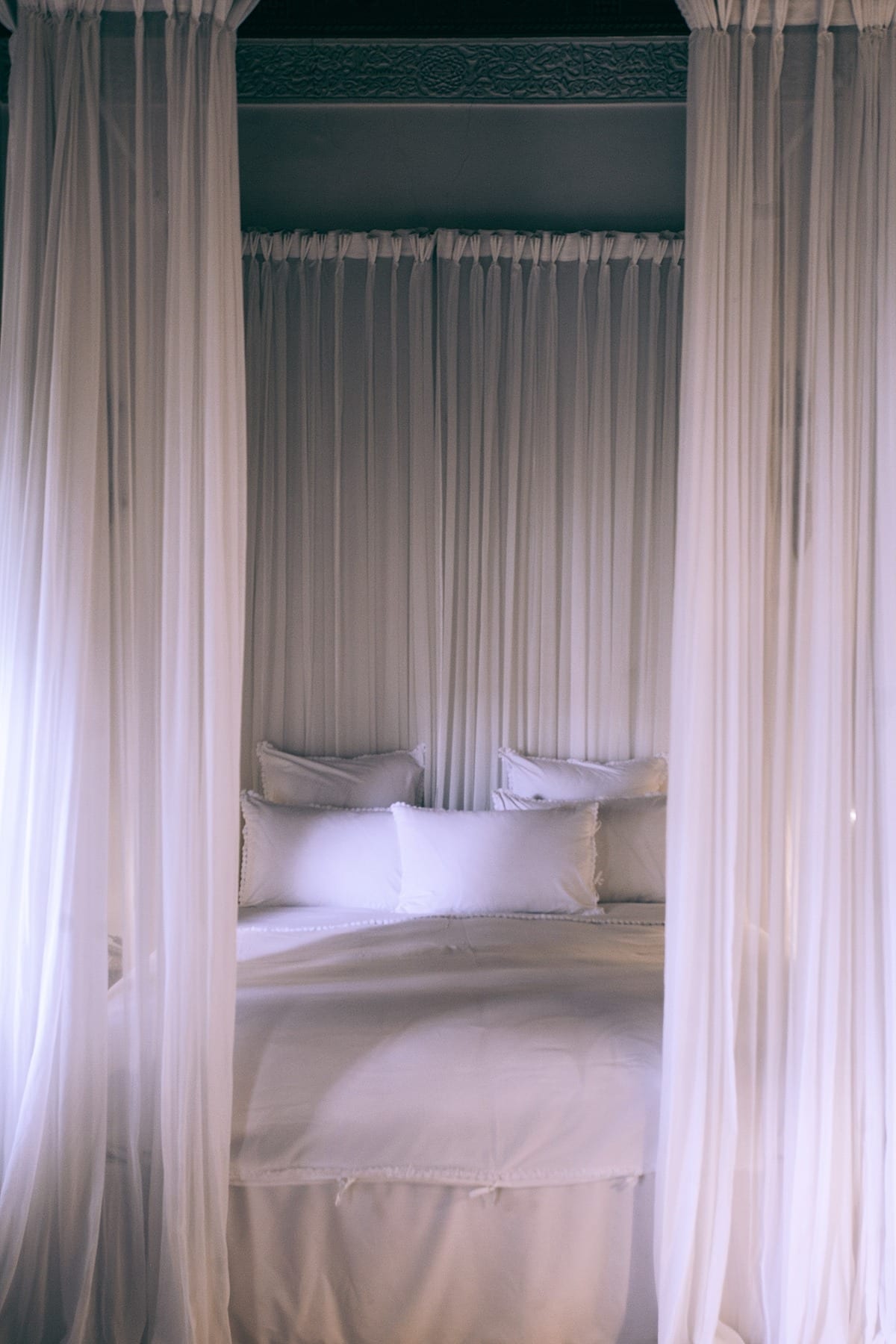 All-white bed with canopy
