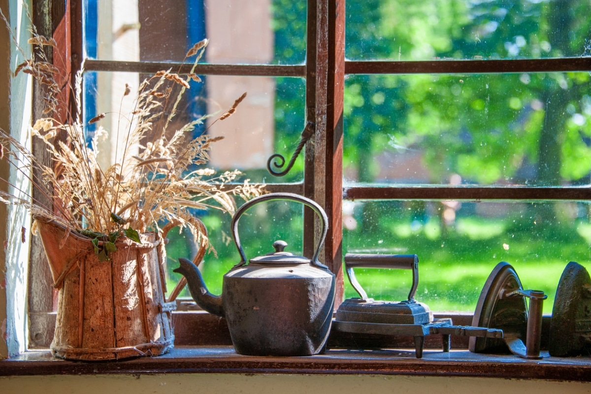 cottage window shelf with vintage kettle and water vase
