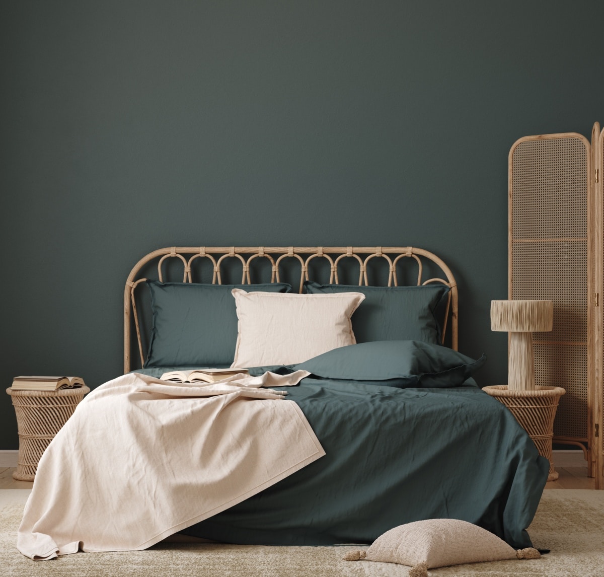 Dark blue-green bedroom interior with rattan furniture