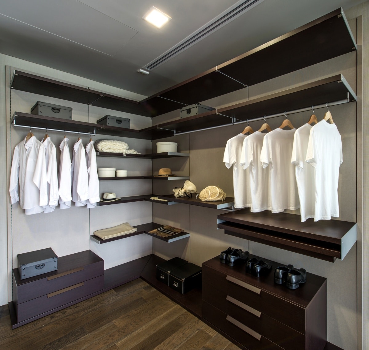 walk-in closet with dark brown shelves and racks