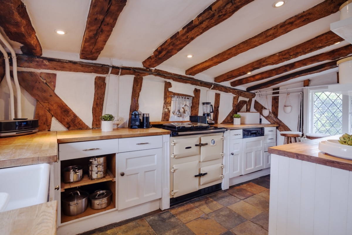 modern english cottage with exposed timber, cupboards, and countertops