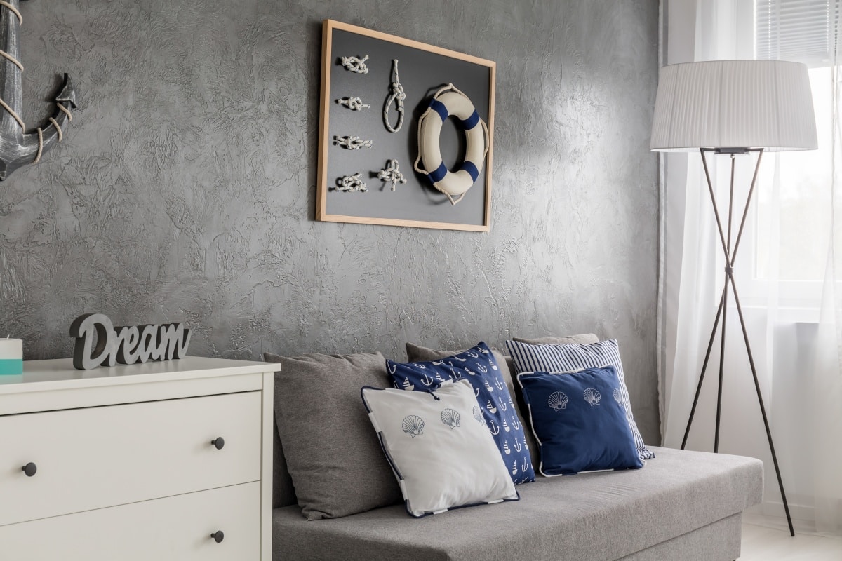 grey room with nautical decorations, sofa and floor lamp