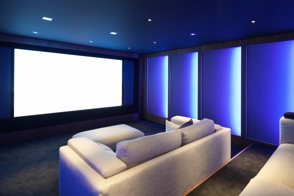 Home theater with luxury interior, comfortable couch and big screen