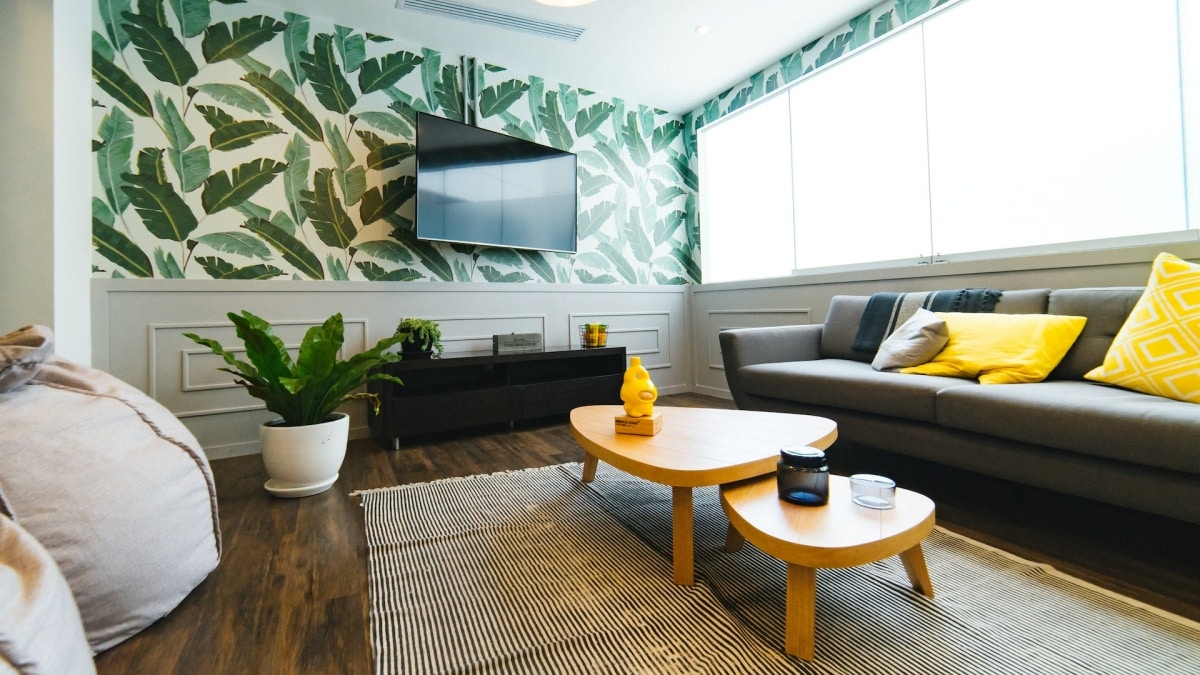 Communal lounge room in yellow, green, and grey