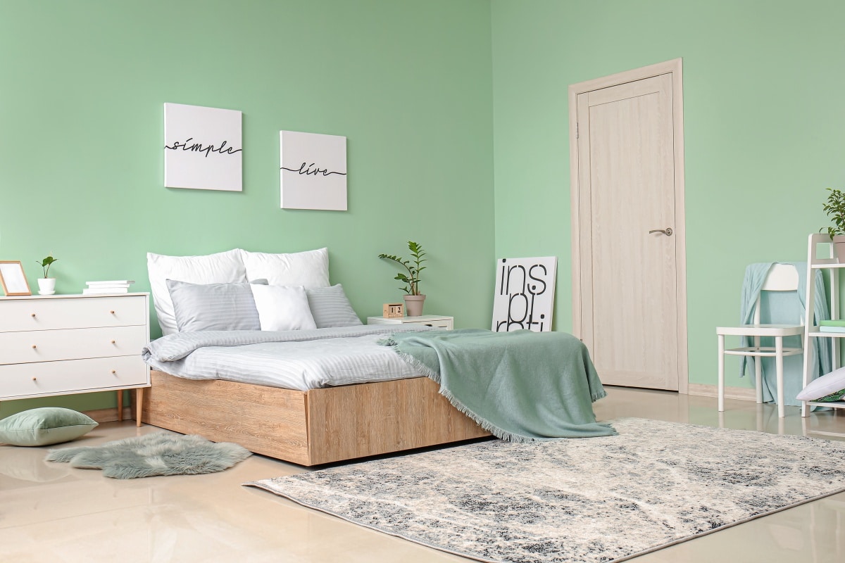 Interior of modern stylish bedroom in mint green theme
