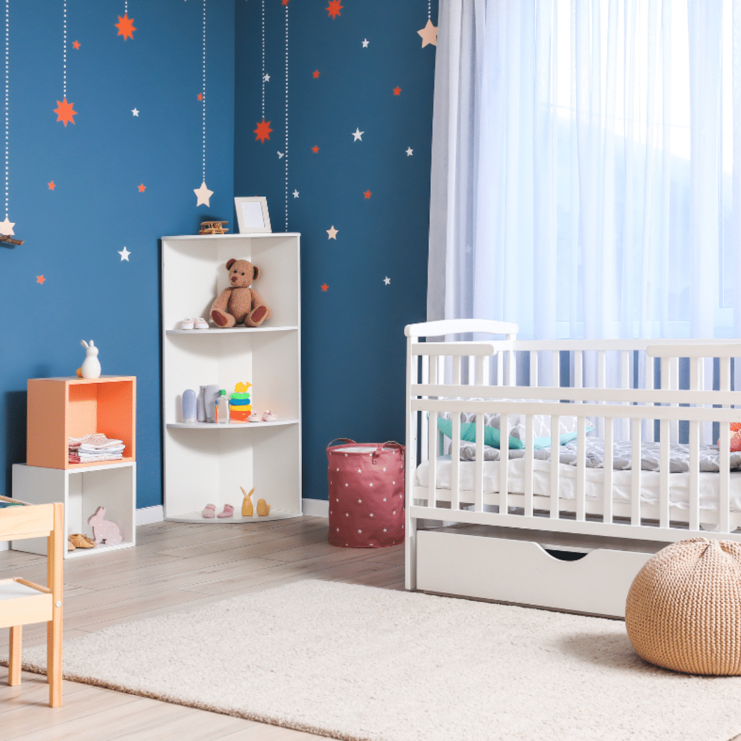 a fully furnished nursery with blue walls