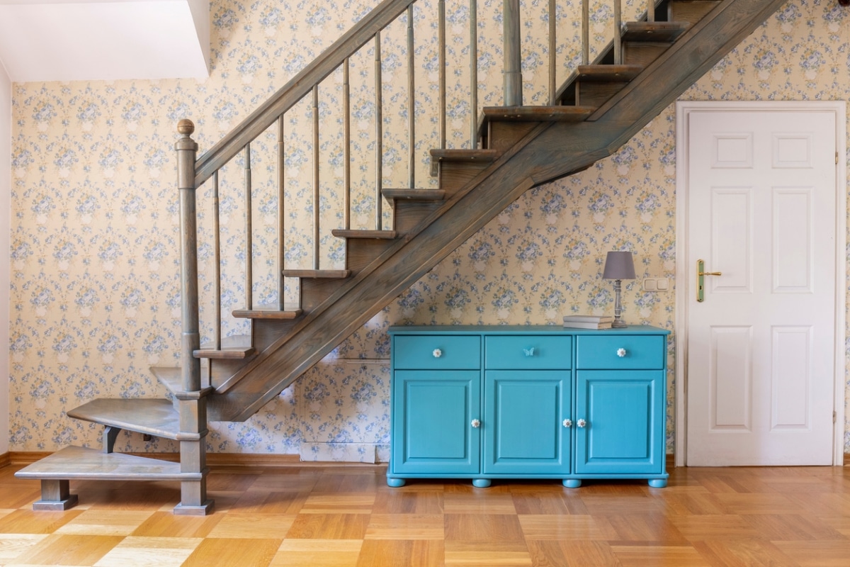 bright blue cabinet against flower patterned wallpaper