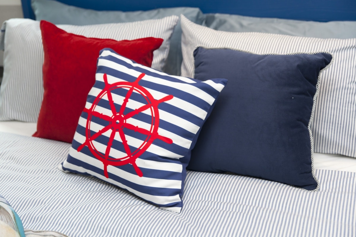 red and blue pillows on a bed