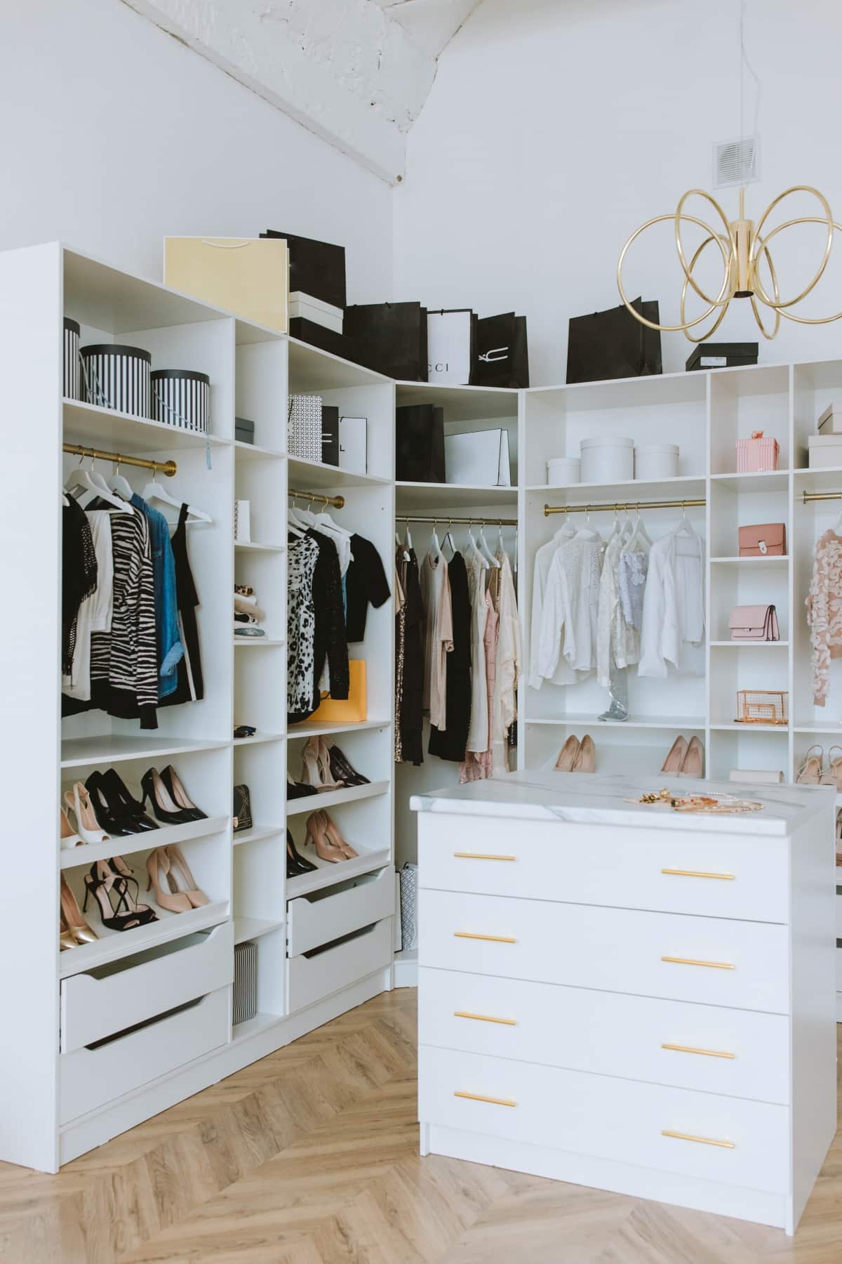White walk-in closet with shoes and clothes
