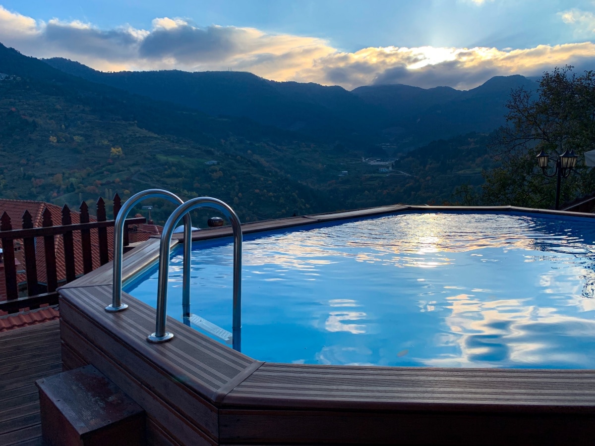 Wood above-ground pool on side of a property with mountain views
