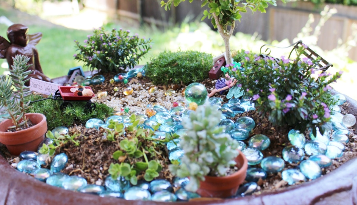 Fairy Garden in a large bird bath with blue rocks and miniature plants