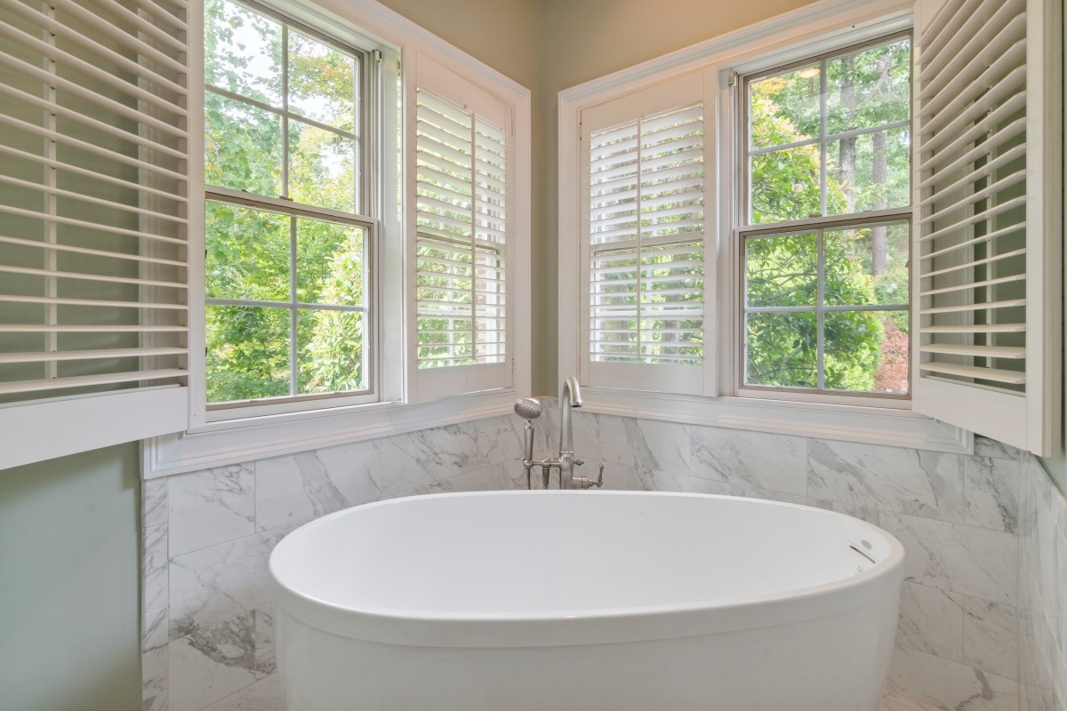 Bathroom with white shuttered windows