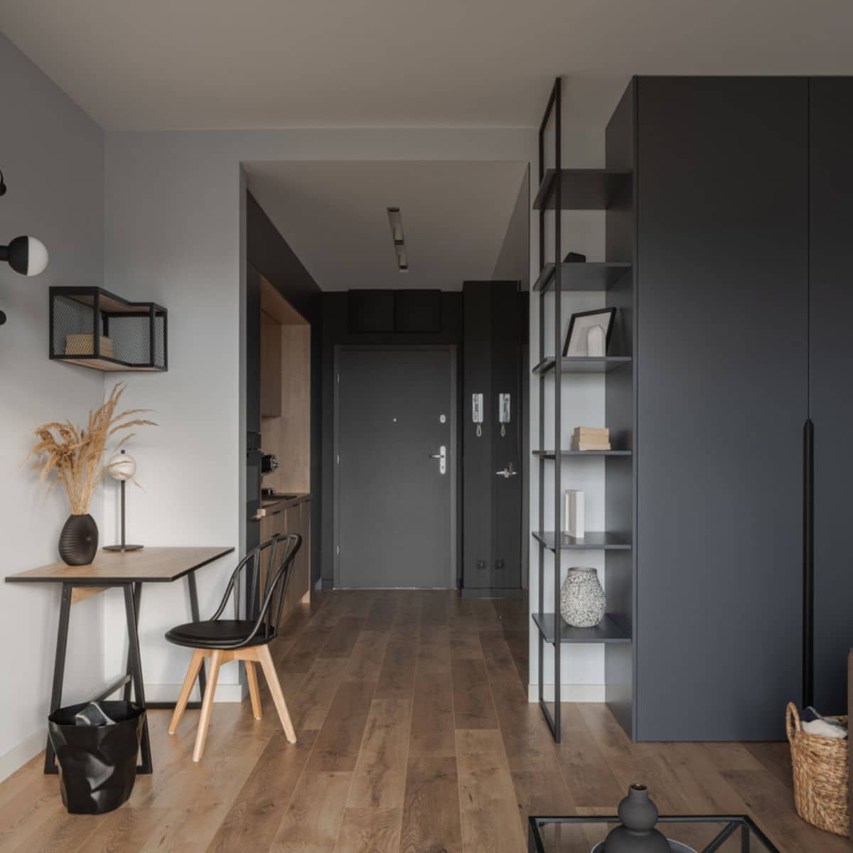 a hallway with black accents on the wall and furniture