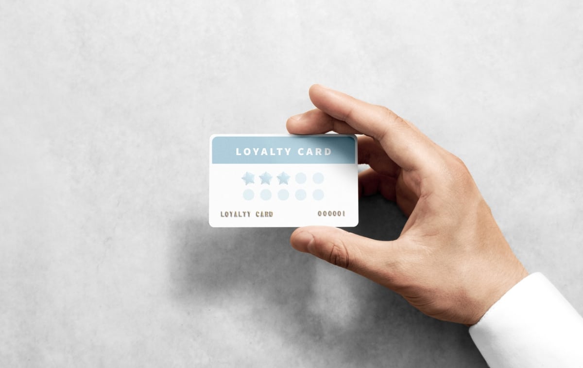 Person holding up a loyalty card