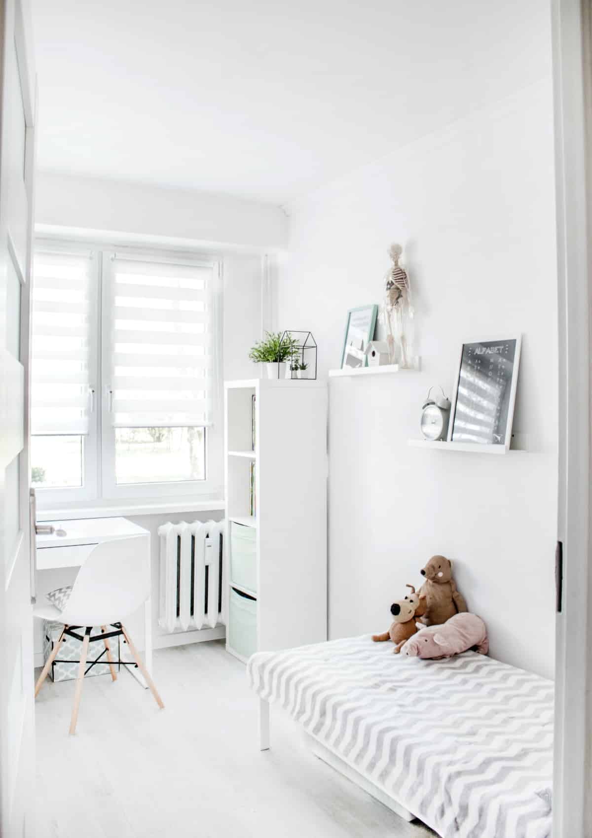 Plush Toys on Top of White and Grey Mattress Inside Bedroom with blinds on window