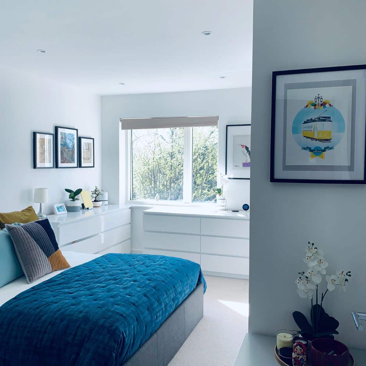 a teal and white bedroom with modern decor