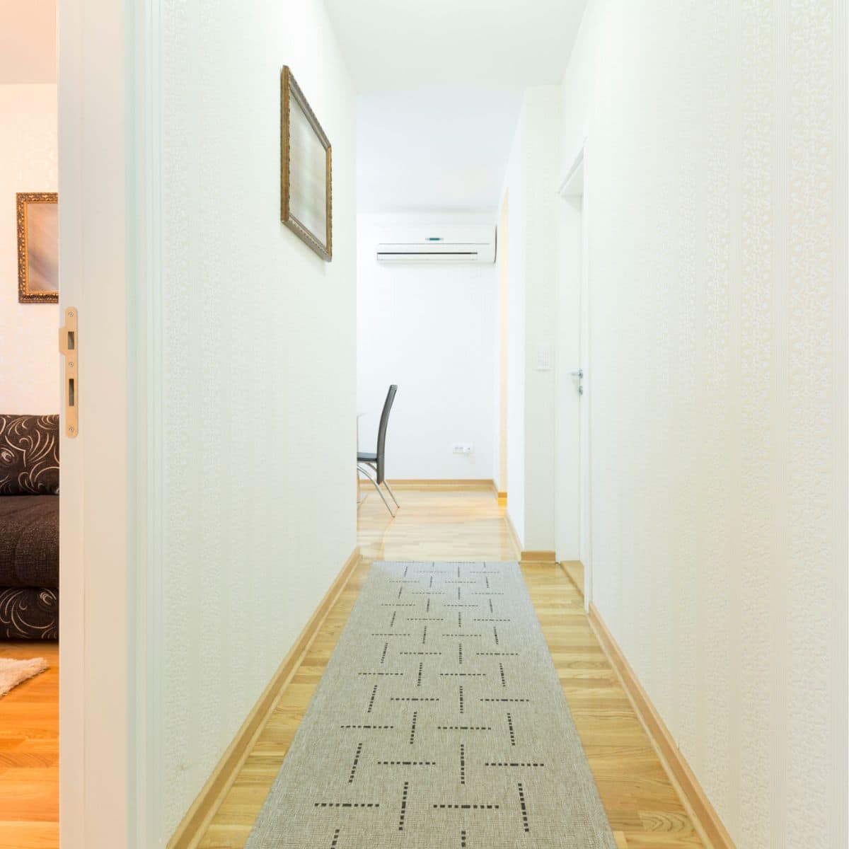 a hallway with a long rug