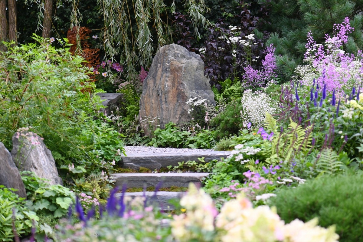 Big rocks planted with shade tolerant cottage garden style plants