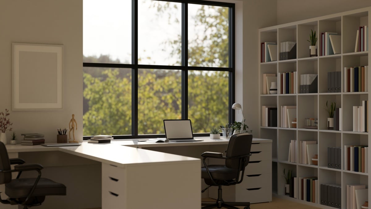Interior design of a modern contemporary and minimal white office workspace with laptop and wide window