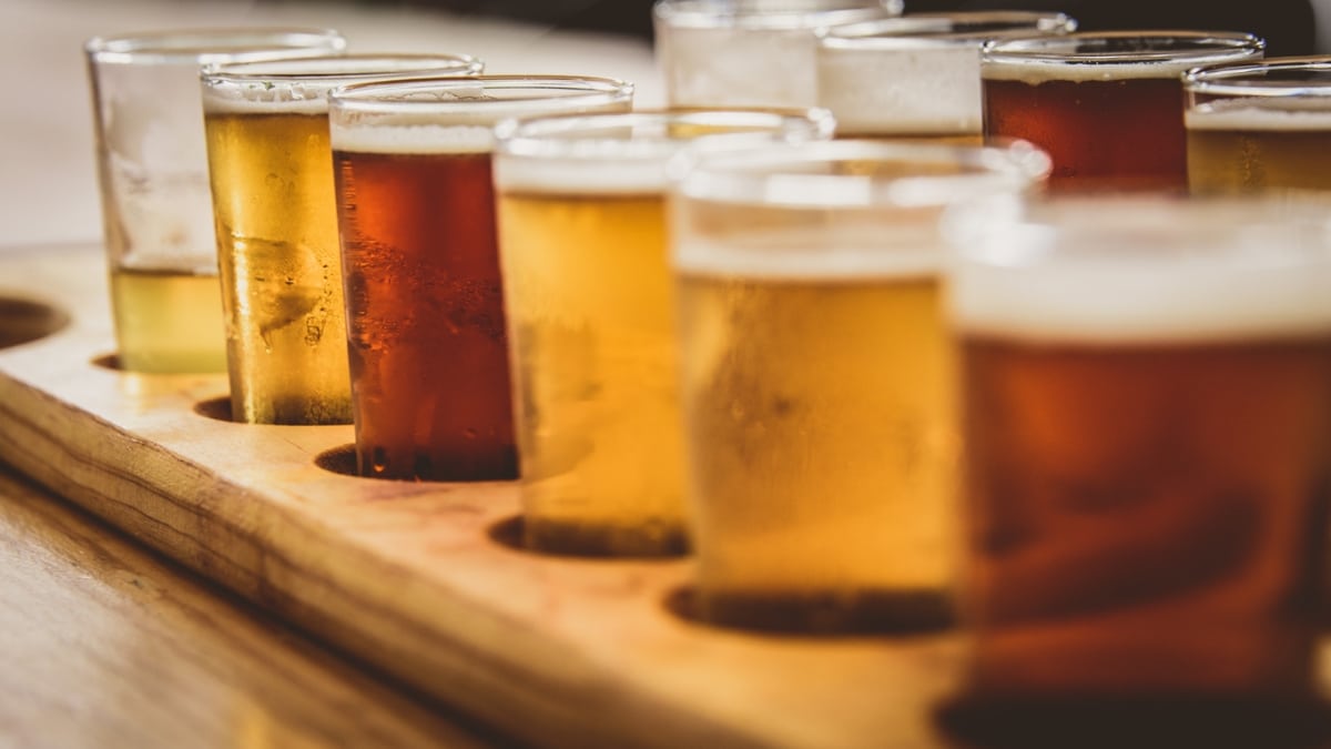 A close up of glasses filled with different brews of beer.