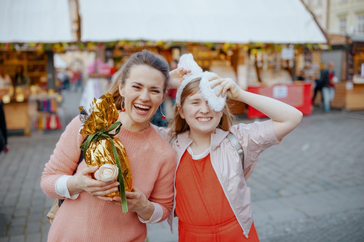 A photo of a mother and daughter smiling and having a good time in an Easter fair.