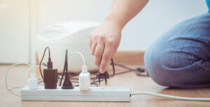 man unplugging appliance to save money on energy bills
