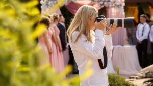 Wedding photographer with a professional camera working at a wedding ceremony.